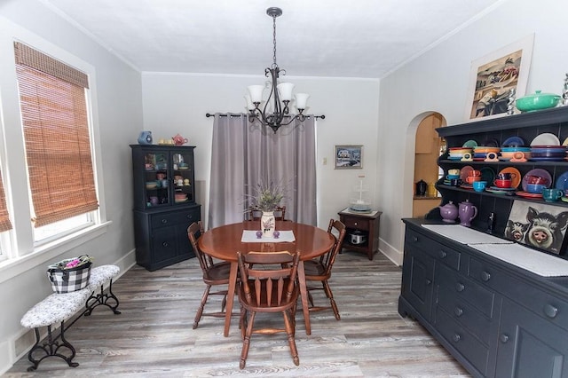 124 Clarendon Ave, South Union Twp, PA 15401 - dining room with a chandelier, arched walkways, light wood-type flooring, crown molding, and baseboards