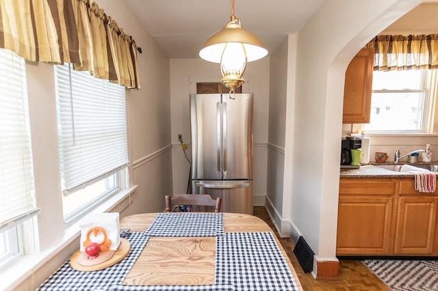 124 Clarendon Ave, South Union Twp, PA 15401 - kitchen featuring freestanding refrigerator, a sink, arched walkways, pendant lighting, and baseboards