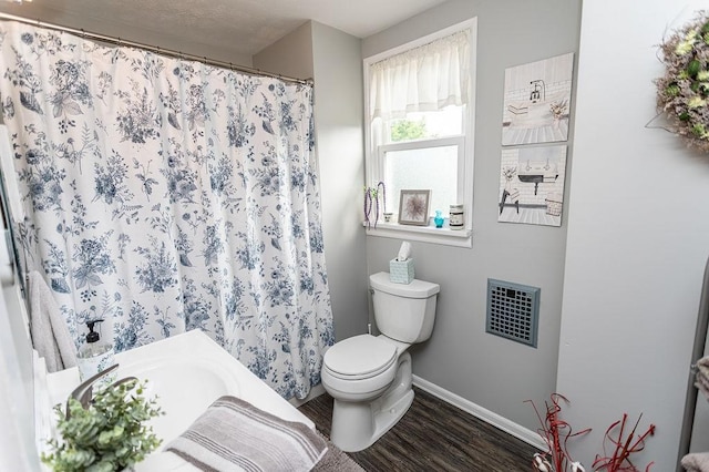 124 Clarendon Ave, South Union Twp, PA 15401 - bathroom featuring wood finished floors, baseboards, toilet, a bath, and a shower with curtain