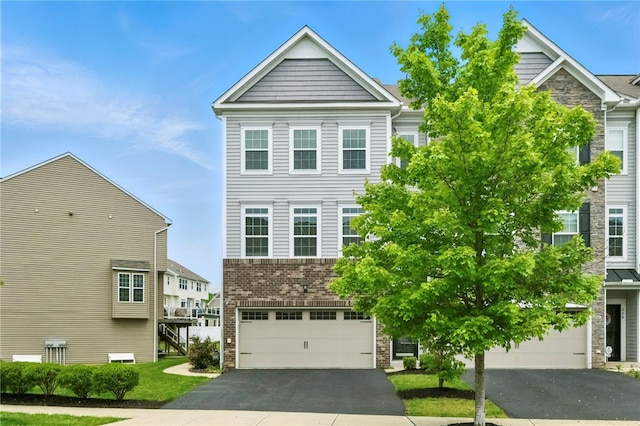 228 Eagle Dr, Cranberry Twp, PA 16066 - view of front of home with driveway, an attached garage, stone siding, and brick siding