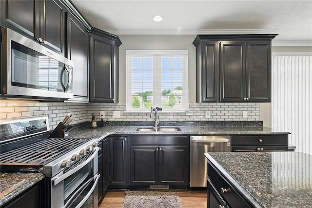 228 Eagle Dr, Cranberry Twp, PA 16066 - kitchen with appliances with stainless steel finishes, a sink, dark cabinetry, wood finished floors, and crown molding