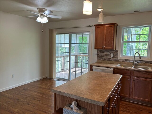 607 Crestview Ln, Lower Burrell, PA 15068 - kitchen featuring a sink, white dishwasher, dark wood-type flooring, decorative backsplash, and a ceiling fan