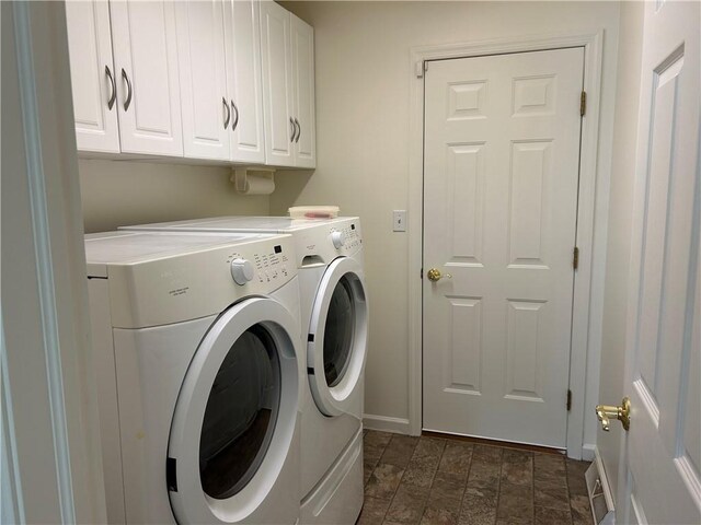 607 Crestview Ln, Lower Burrell, PA 15068 - washroom featuring separate washer and dryer, baseboards, cabinet space, and stone finish flooring