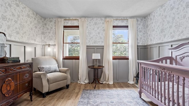 201 Clarke Rd, Buffalo Twp Wsh, PA 15323 - bedroom featuring multiple windows, wood finished floors, a wainscoted wall, a crib, and wallpapered walls