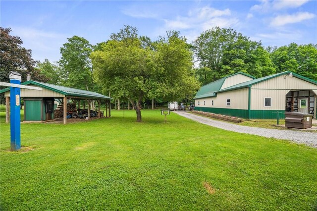 500 Kinsman Rd, Green Twp, PA 16134 - view of grassy yard with a pole building, an outdoor structure, and view of wooded area