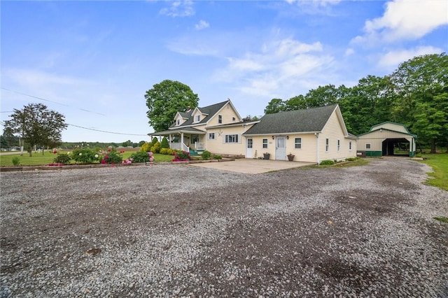 500 Kinsman Rd, Green Twp, PA 16134 - view of front of home featuring driveway, a detached carport, and a porch