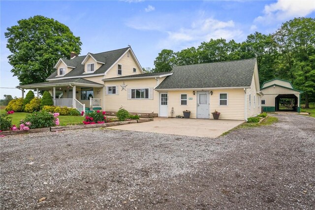 500 Kinsman Rd, Green Twp, PA 16134 - view of front of house featuring a carport, a porch, a shingled roof, and gravel driveway