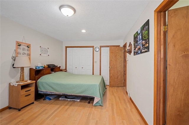 500 Kinsman Rd, Green Twp, PA 16134 - bedroom with light wood-type flooring, baseboards, two closets, a textured ceiling, and recessed lighting