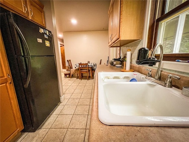 248 Jamisonville Rd, Center Twp But, PA 16001 - kitchen with freestanding refrigerator, a sink, light countertops, brown cabinetry, and backsplash