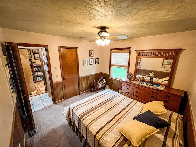 248 Jamisonville Rd, Center Twp But, PA 16001 - bedroom featuring carpet floors, wainscoting, wood walls, a textured ceiling, and a ceiling fan