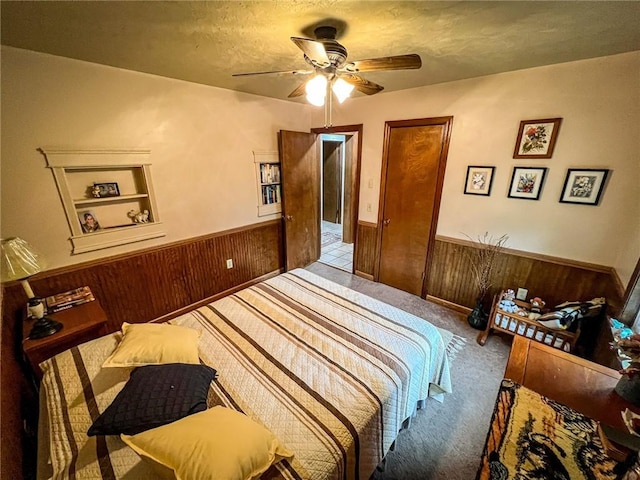 248 Jamisonville Rd, Center Twp But, PA 16001 - carpeted bedroom with wainscoting, wood walls, and a ceiling fan