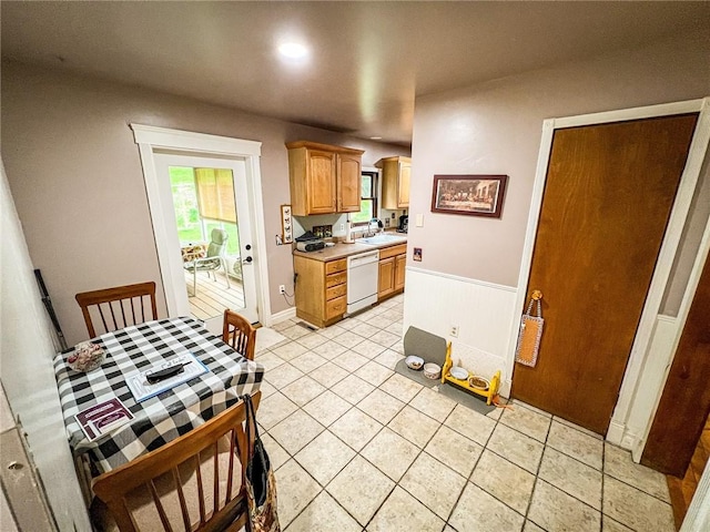 248 Jamisonville Rd, Center Twp But, PA 16001 - kitchen with white dishwasher, a sink, light countertops, light tile patterned floors, and wainscoting