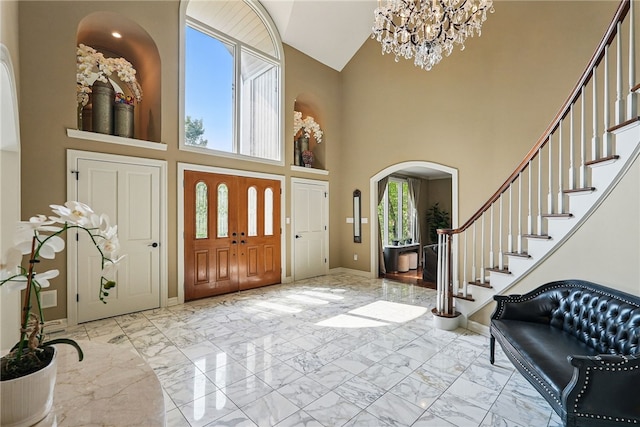 559 Normandy Ct, Fox Chapel, PA 15238 - entryway featuring arched walkways, light marble finish flooring, baseboards, and high vaulted ceiling