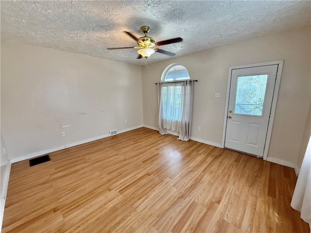 121-123 4th Ave, Scottdale, PA 15683 - unfurnished room featuring plenty of natural light, light wood-style flooring, a ceiling fan, a textured ceiling, and baseboards