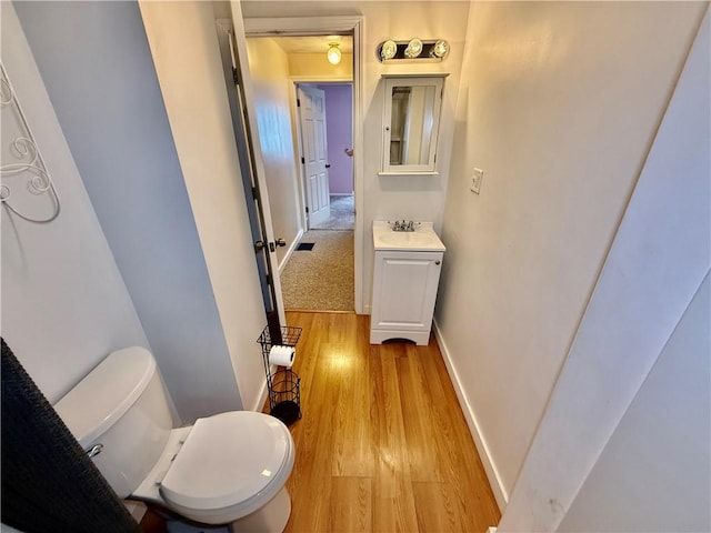 121-123 4th Ave, Scottdale, PA 15683 - half bath featuring vanity, wood finished floors, toilet, and baseboards