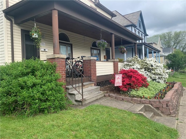 121-123 4th Ave, Scottdale, PA 15683 - view of exterior entry featuring a porch and a shingled roof