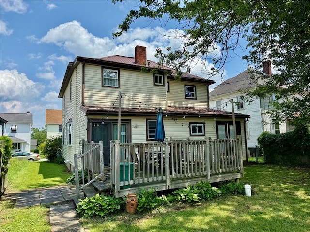 121-123 4th Ave, Scottdale, PA 15683 - back of property with a chimney, a yard, a deck, and metal roof
