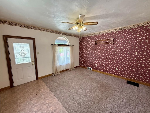 121-123 4th Ave, Scottdale, PA 15683 - carpeted foyer entrance featuring healthy amount of natural light, wallpapered walls, ceiling fan, baseboards, and a textured ceiling