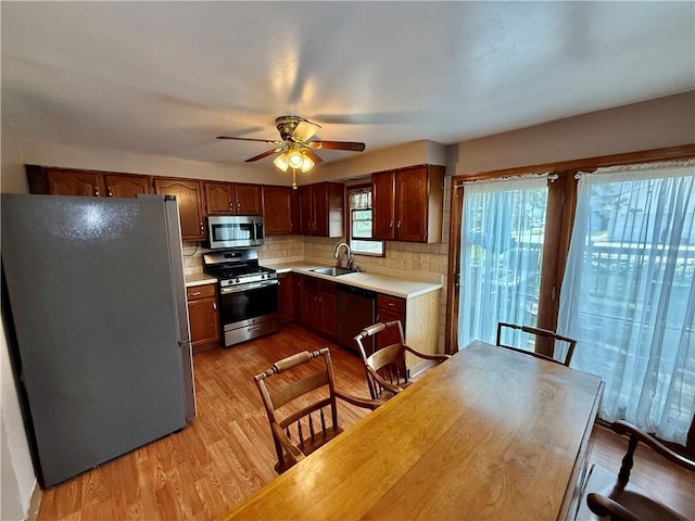 121-123 4th Ave, Scottdale, PA 15683 - kitchen with appliances with stainless steel finishes, a sink, light countertops, tasteful backsplash, and ceiling fan