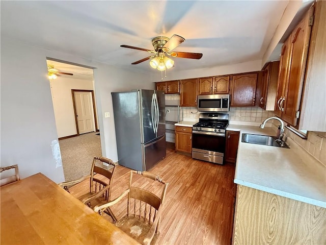 121-123 4th Ave, Scottdale, PA 15683 - kitchen featuring appliances with stainless steel finishes, a sink, ceiling fan, light countertops, and tasteful backsplash