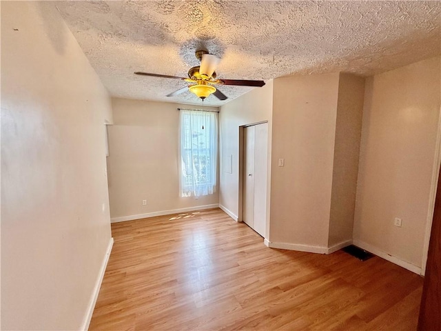 121-123 4th Ave, Scottdale, PA 15683 - spare room featuring light wood-type flooring, ceiling fan, baseboards, and a textured ceiling