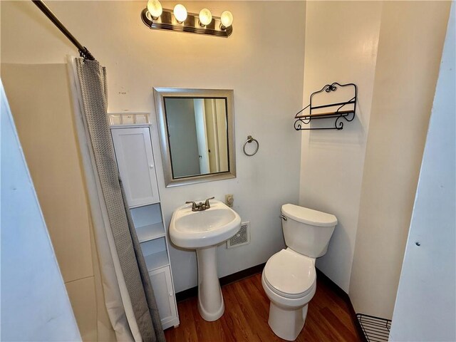 121-123 4th Ave, Scottdale, PA 15683 - full bath featuring wood finished floors, toilet, and a shower with curtain