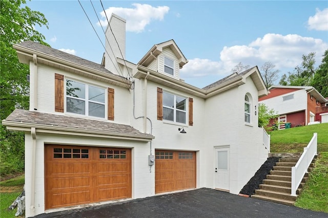 10 Neptune Dr, Robinson Twp Nwa, PA 15136 - view of front of house with a garage, driveway, a chimney, and stairs