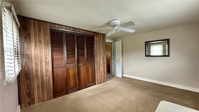 820-822 Main St, Springdale Twp, PA 15049 - unfurnished bedroom with a closet, carpet flooring, baseboards, a ceiling fan, and wooden walls