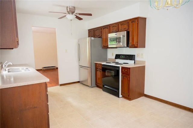 452 Cherokee Dr, Center Twp But, PA 16001 - kitchen with range with electric stovetop, freestanding refrigerator, a sink, a baseboard radiator, and light countertops