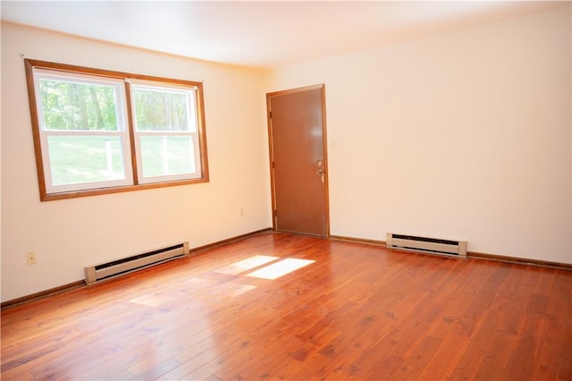 452 Cherokee Dr, Center Twp But, PA 16001 - empty room featuring a baseboard heating unit, hardwood / wood-style flooring, and baseboards