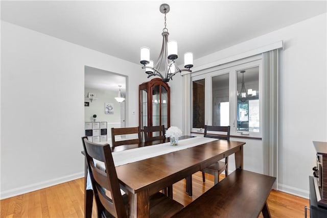 404 Neola Cir, Ross Twp, PA 15237 - dining room with a chandelier, light wood finished floors, and baseboards