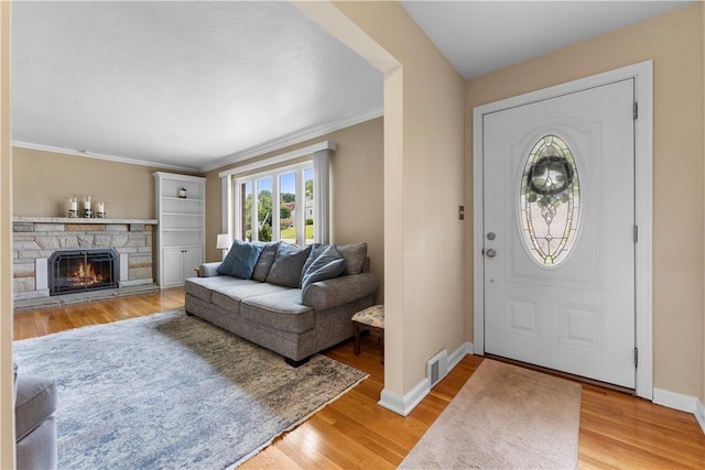 404 Neola Cir, Ross Twp, PA 15237 - entrance foyer with light wood-style flooring, baseboards, crown molding, and a fireplace
