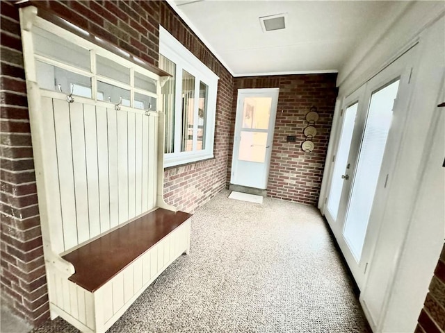 404 Neola Cir, Ross Twp, PA 15237 - mudroom featuring brick wall, plenty of natural light, and carpet floors