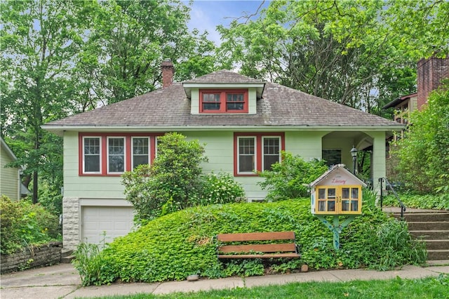 203 W Hutchinson Ave, Regent Square, PA 15218 - view of front of property featuring an attached garage, a chimney, concrete driveway, and roof with shingles