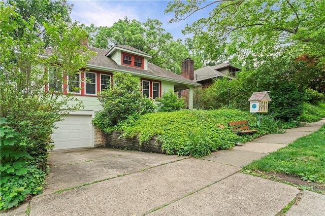 203 W Hutchinson Ave, Regent Square, PA 15218 - view of front of house featuring a chimney, concrete driveway, and an attached garage