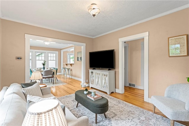 203 W Hutchinson Ave, Regent Square, PA 15218 - living area with light wood-type flooring, ornamental molding, and a textured ceiling