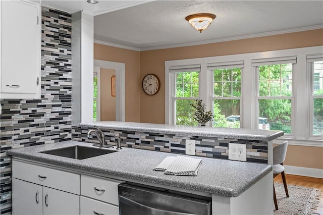 203 W Hutchinson Ave, Regent Square, PA 15218 - kitchen with stainless steel dishwasher, backsplash, wood finished floors, plenty of natural light, and crown molding