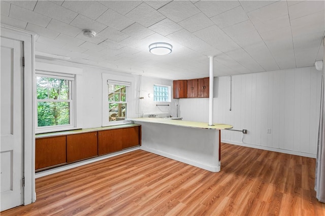 203 W Hutchinson Ave, Regent Square, PA 15218 - kitchen with light wood-style floors, brown cabinets, a peninsula, and light countertops