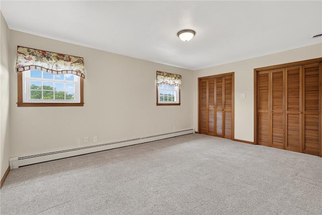 1990 Robbins Station Rd, North Huntingdon, PA 15642 - unfurnished bedroom with two closets, baseboard heating, multiple windows, and carpet