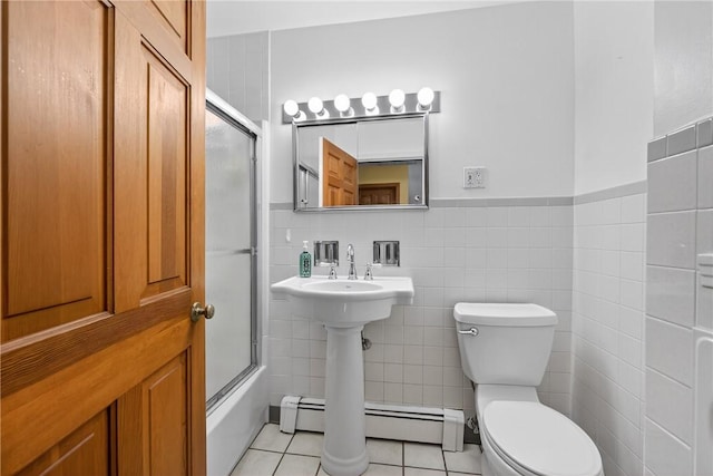 1990 Robbins Station Rd, North Huntingdon, PA 15642 - full bathroom with tile walls, tile patterned flooring, a wainscoted wall, shower / bath combination with glass door, and a baseboard radiator
