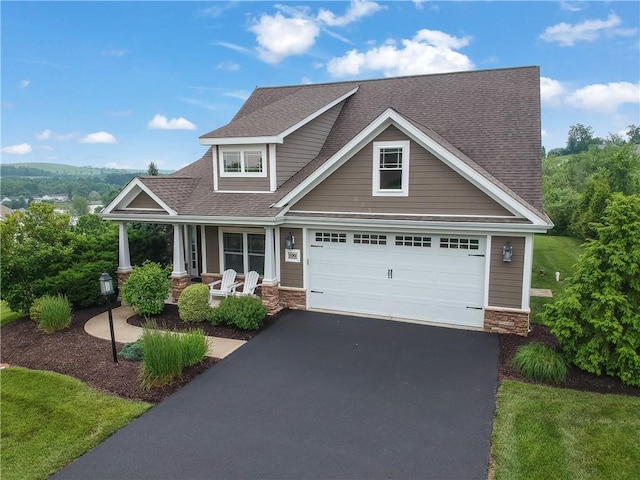 109 Summer Ln, Mount Pleasant Twp Was, PA 15057 - craftsman inspired home with covered porch, stone siding, asphalt driveway, and a shingled roof