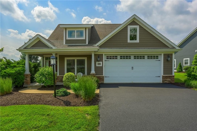 109 Summer Ln, Mount Pleasant Twp Was, PA 15057 - craftsman-style house featuring driveway, a garage, a porch, stone siding, and a shingled roof