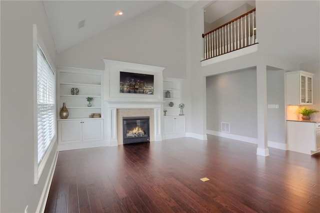 109 Summer Ln, Mount Pleasant Twp Was, PA 15057 - unfurnished living room with dark wood-style floors, a glass covered fireplace, high vaulted ceiling, and built in features
