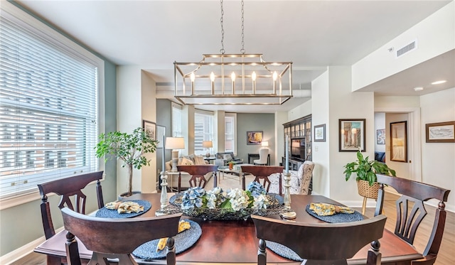 306 4th Ave Unit 902, Downtown Pgh, PA 15222 - dining space featuring wood finished floors and a chandelier