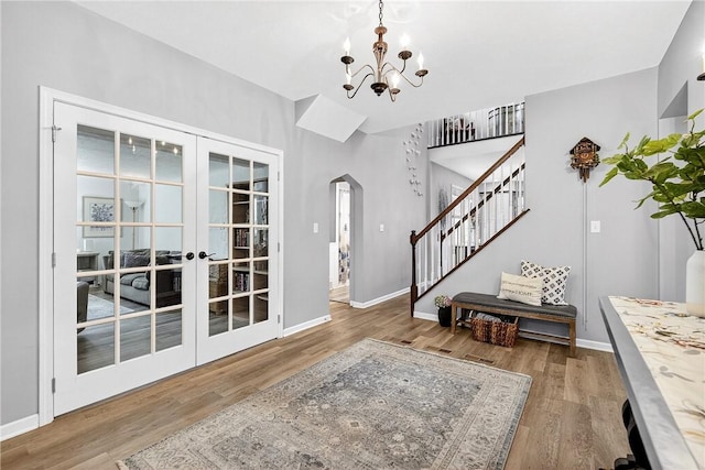 711 SE Simpson Howell, Elizabeth Twp/Boro, PA 15037 - entryway with arched walkways, a chandelier, stairway, and wood finished floors