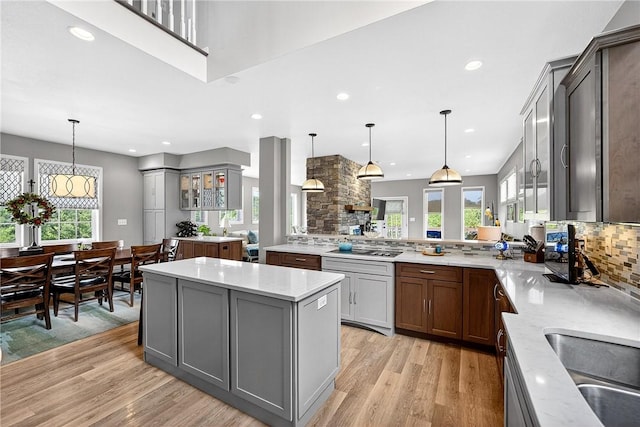 711 SE Simpson Howell, Elizabeth Twp/Boro, PA 15037 - kitchen featuring light wood finished floors, healthy amount of natural light, backsplash, gray cabinets, and recessed lighting