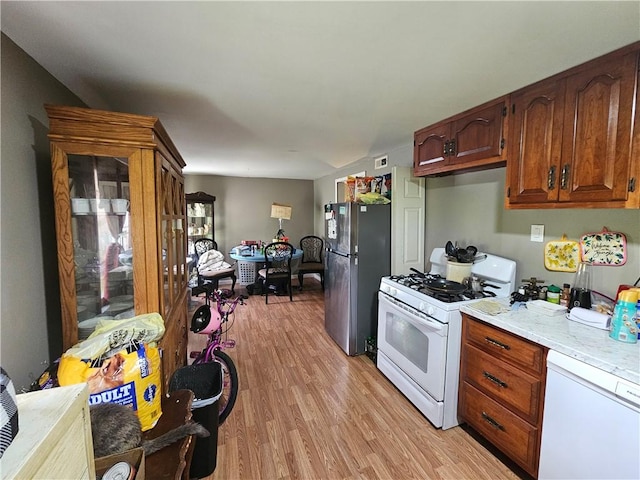 105 Longfellow St, Vandergrift Wml, PA 15690 - kitchen featuring white appliances, light wood-type flooring, light countertops, and brown cabinetry