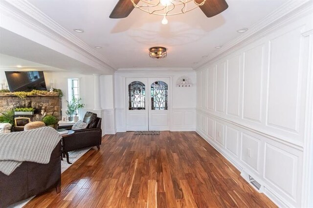 33 Chalkhill Ohiopyle Rd, Wharton Twp, PA 15470 - entrance foyer featuring a decorative wall, ceiling fan, wood finished floors, a fireplace, and ornamental molding