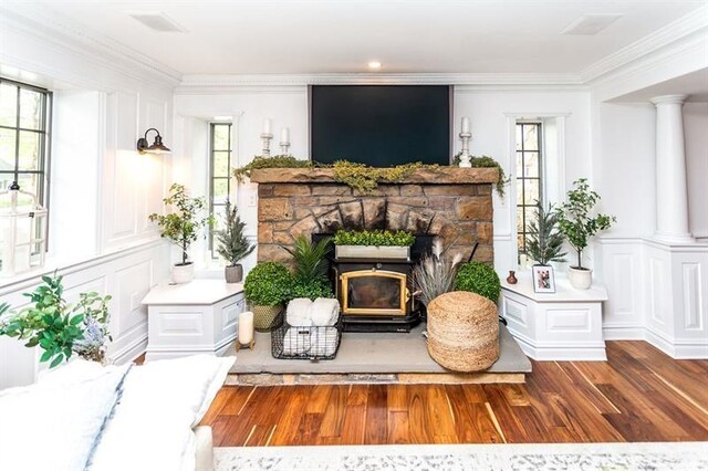 33 Chalkhill Ohiopyle Rd, Wharton Twp, PA 15470 - living area featuring wood finished floors, healthy amount of natural light, a fireplace with raised hearth, and crown molding