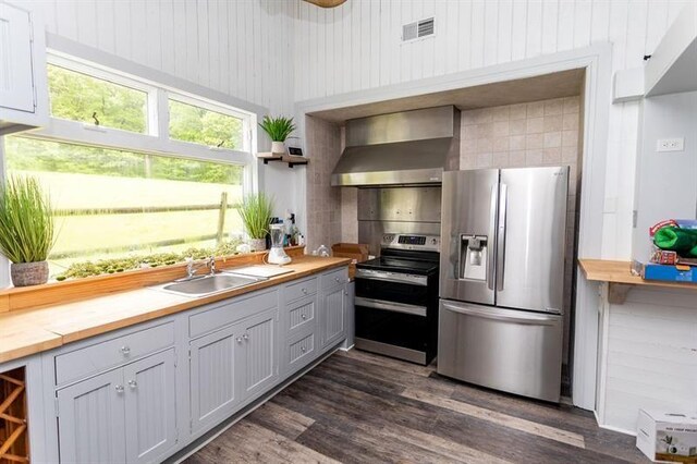 33 Chalkhill Ohiopyle Rd, Wharton Twp, PA 15470 - kitchen with stainless steel appliances, wall chimney exhaust hood, butcher block countertops, open shelves, and dark wood finished floors
